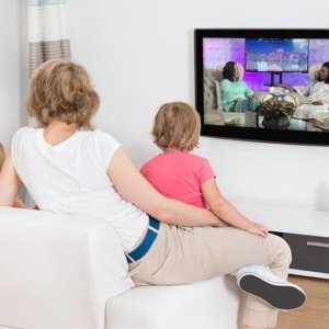 Young Family Watching TV Together